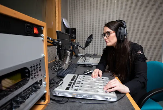 A UL journalism student broadcasting from a media lab