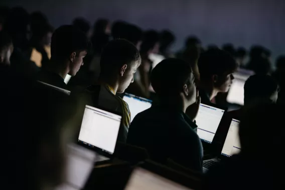 Students at laptops in lecture theatre