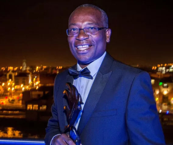 Dr Mark Mantey holding his UL Alumni Award