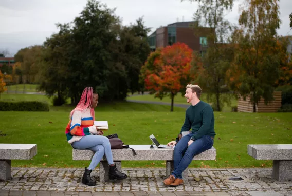 Students sat on bench on the UL Plaza