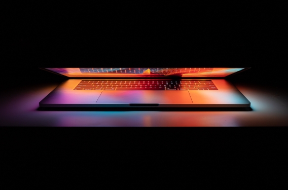Laptop open in dark room
