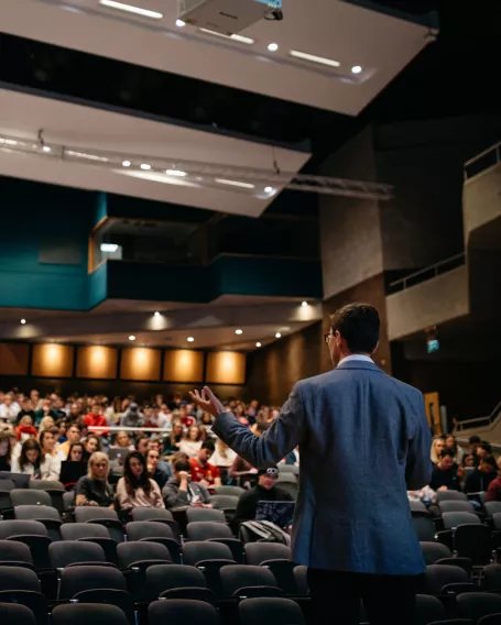 lecturer speaking to students in lecture hall