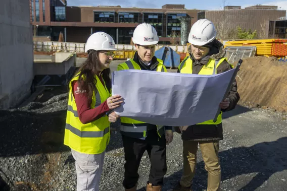 A group looking at plans for the student centre