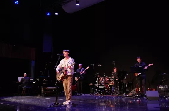 Man singing and playing guitar