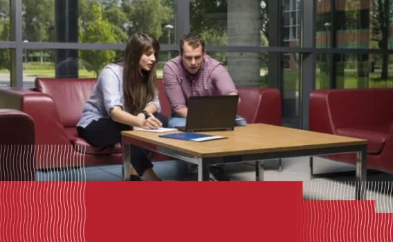 man and a woman looking at a laptop