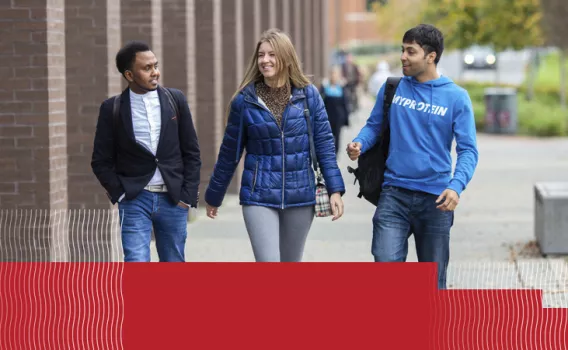 3 mature students walking on campus