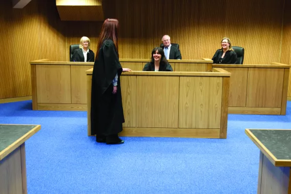 Students wearing legal robes in the UL moot court