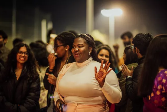 UL Global Ambassador Lucy Edith shows off her henna tattoo among smiling Diwali 2023 guests 