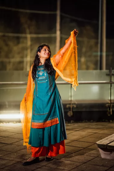 Diwali 2023 guest shows off her traditional clothing in front of the pitches at the Pavilion