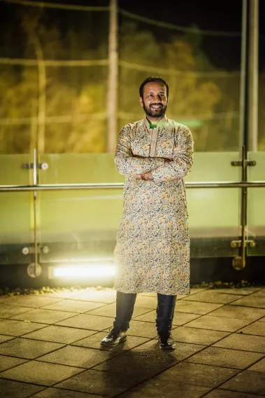 Diwali 2023 guest shows off his traditional clothing in front of the pitches at the Pavilion