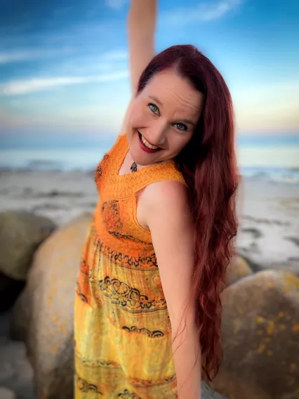 Smiling woman standing on rocks