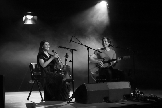 Two people on stage playing music