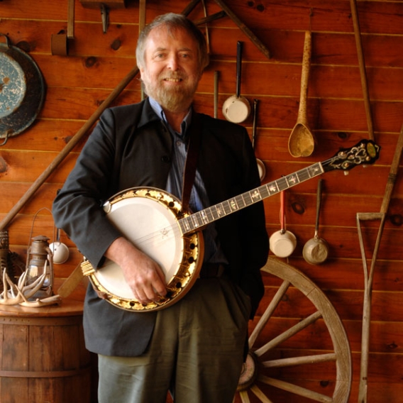 Mick Moloney holding a banjo