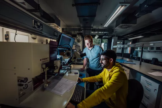 Two people working in a laboratory space