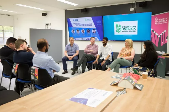 A panel of people discussing with an audience