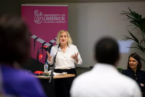 A woman talking from a podium