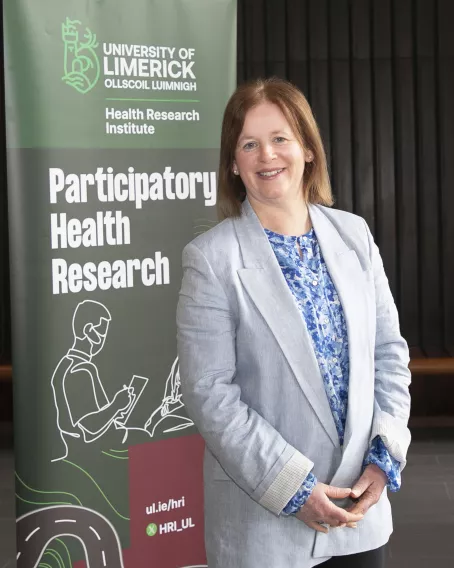 Sylvia Murphy Tighe with PHRU Banner.