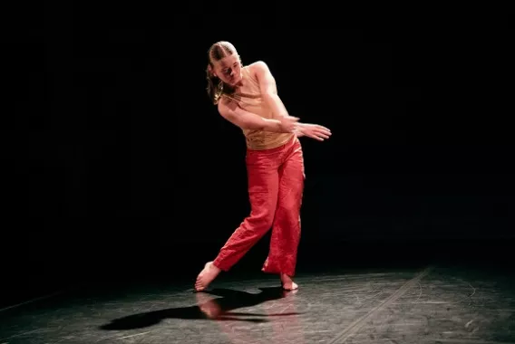 Female student dancing on stage