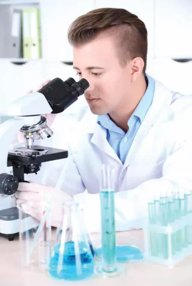 Man looking at scope in lab