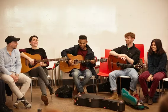 Group of musicians playing guitars in the Irish World Music Cafe