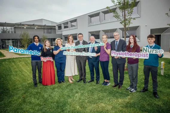 secondary school pupils and staff members from UL holding signs with different healthcare professional titles on them 