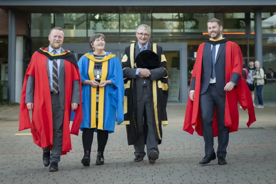 Finbarr Murphy, Sheila Killian, Shane Kilcommins and Barry Sheehan walking outside the Kemmy Business School