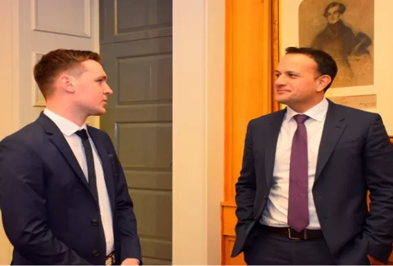 two men in suits looking at one another