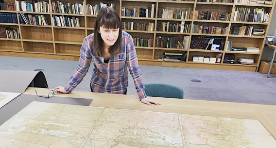 Dr Catherine Porter looking at a map