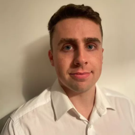 headshot of man in white shirt