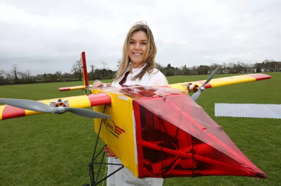 Alison standing with her plane 