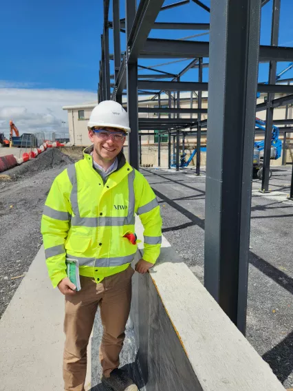 man in high vis on building site