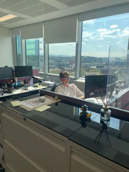 man at desk with sun glasses