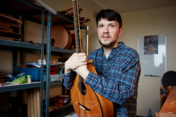 Man holding a bouzouki