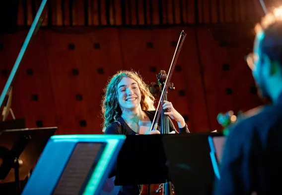 Violinist looking at sheet music and smiling