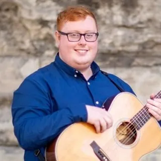 Man holds guitar