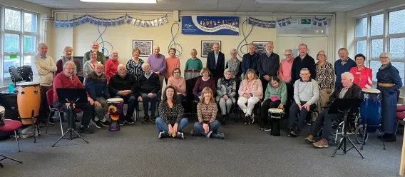 Large group of community participants with drums