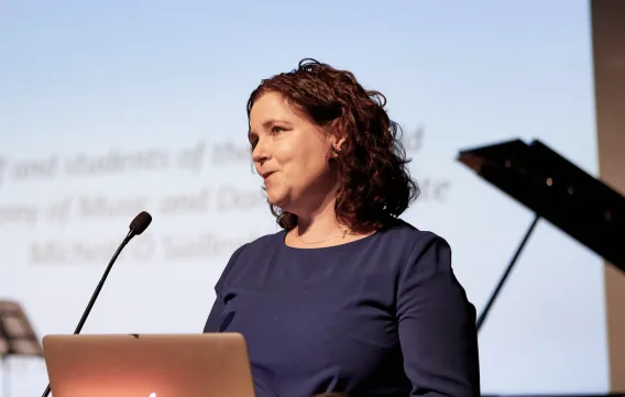 Dr Sandra Joyce speaking at a podium