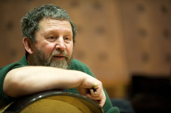 Tommy Hayes leaning on bodhrán