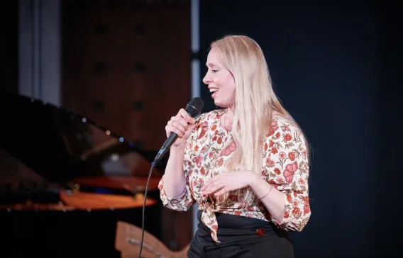 Postgraduate student holding microphone