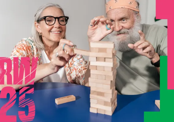 Research Week poster showing a man and a woman at a table playing a block game 