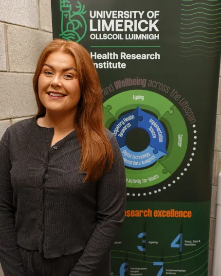 Jade Gill with Health Research Institute banner behind