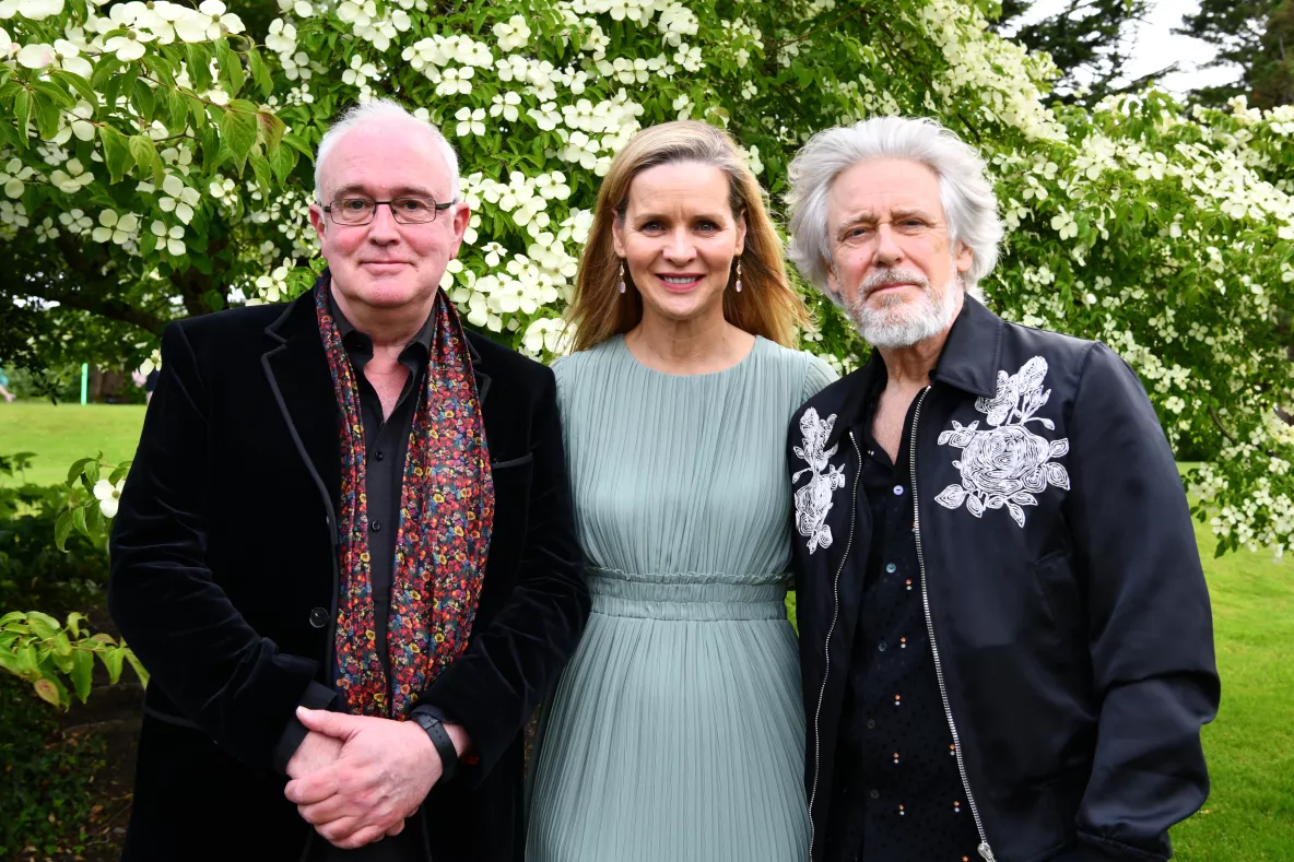 Three people are pictured - a man and two women. It is Professor Joseph O'Connor, Caitríona Fottrell of the Ireland Funds, and Adam Clayton of U2