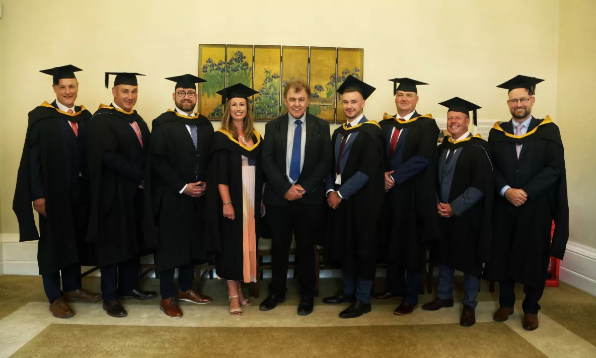 Professor Sean Arkins pictured with some of the first students to graduate with Masters Level Apprenticeships