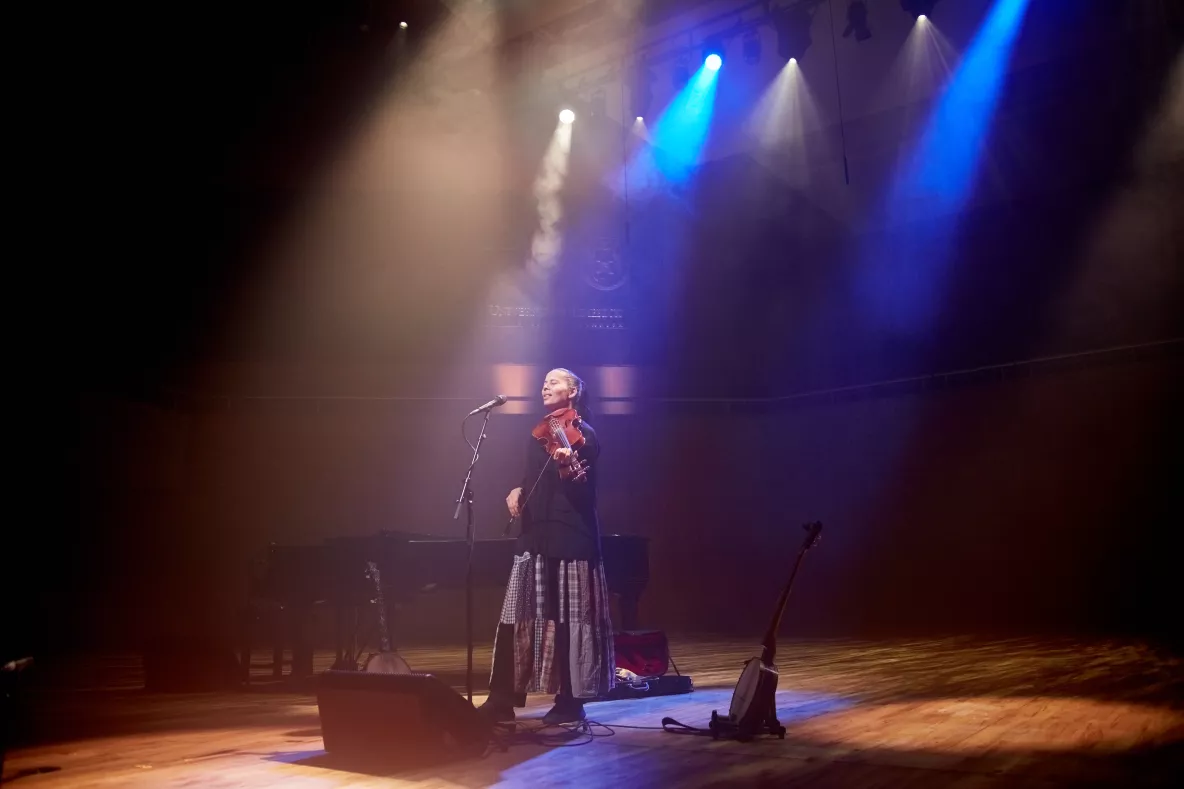 A picture of Rhiannon Giddens in concert at UCH