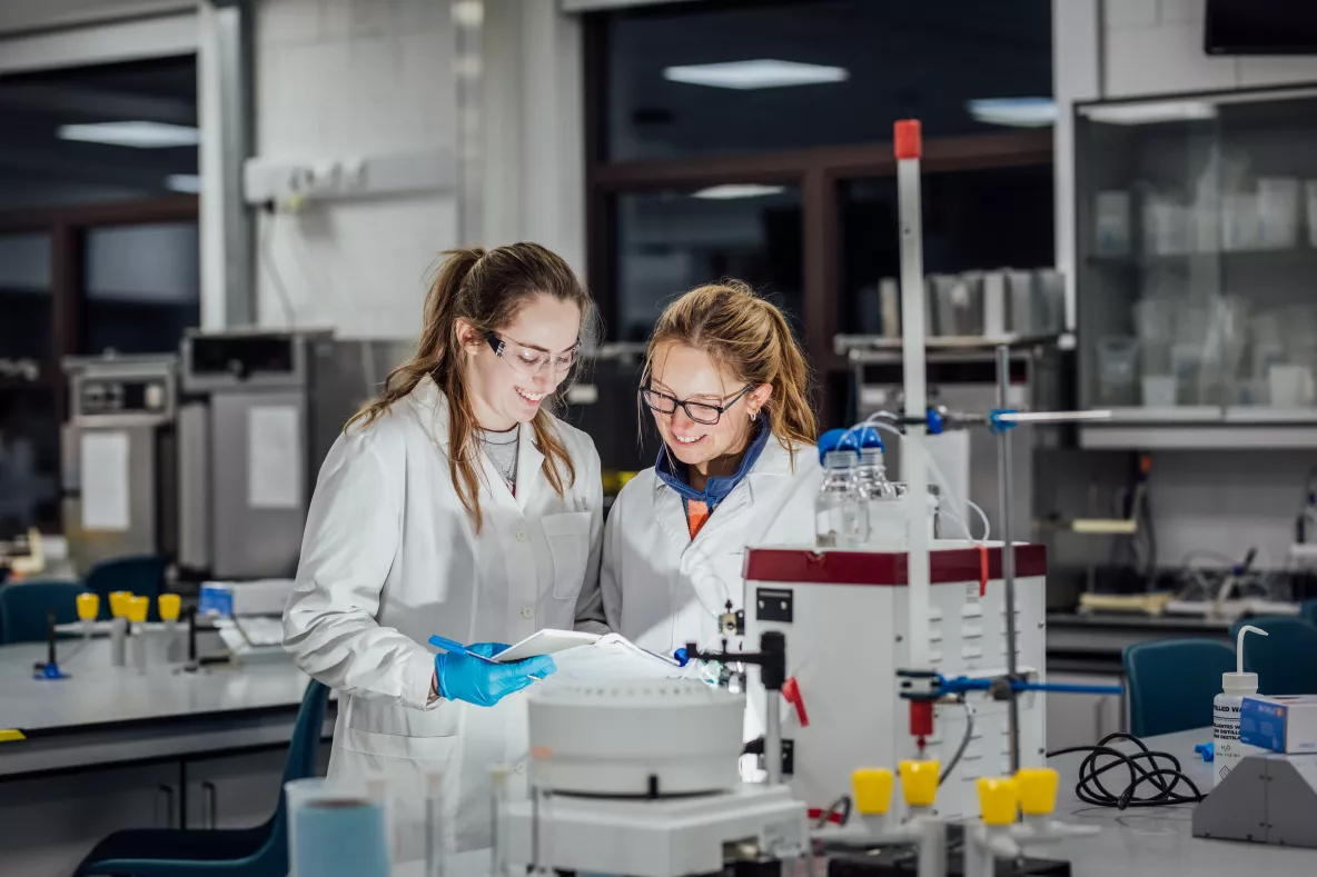 Biological Science Students Elle Sorensen and Georgina Hornsby using the Äkta Start FPLC system in a laboratory at University of Limerick