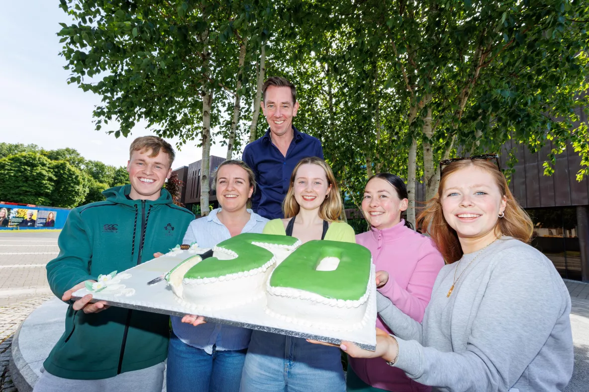 Ryan Tubridy with students and the cake on the UL campus