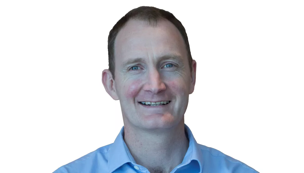 Head shot of Dr Kieran O'Sullivan wearing a blue shirt and smiling