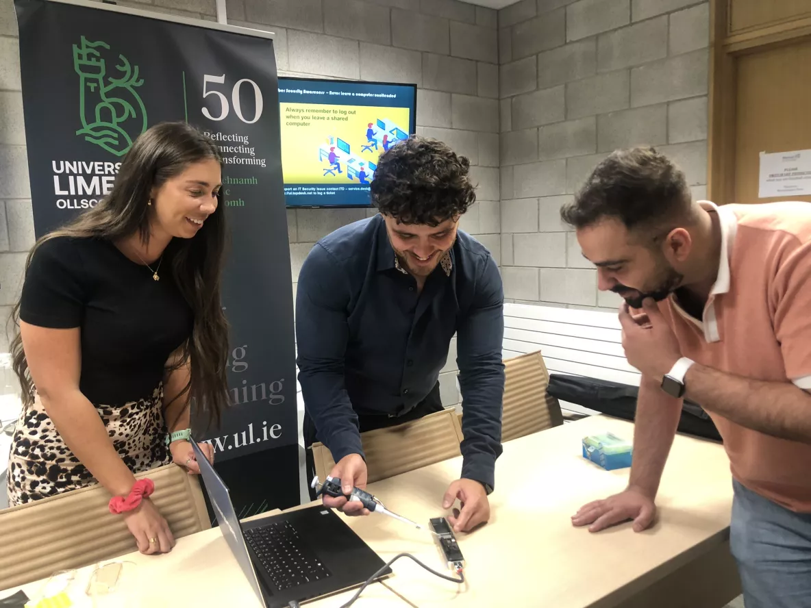 A group looking at a computer in UL