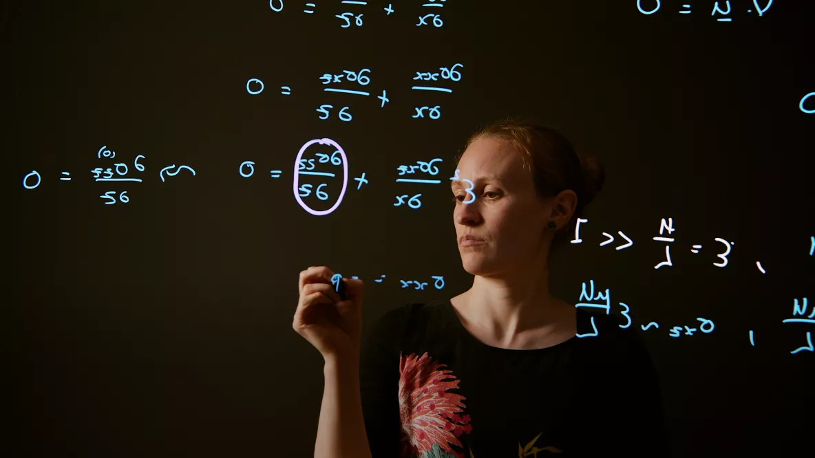 Doireann O’Kiely pictured in front of a screen with blue writing on it