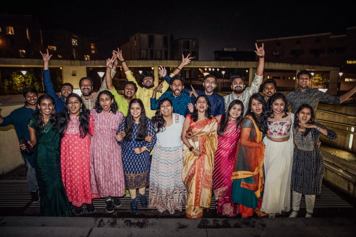 Photo of Diwali 2023 guests smiling outside in their traditional clothing